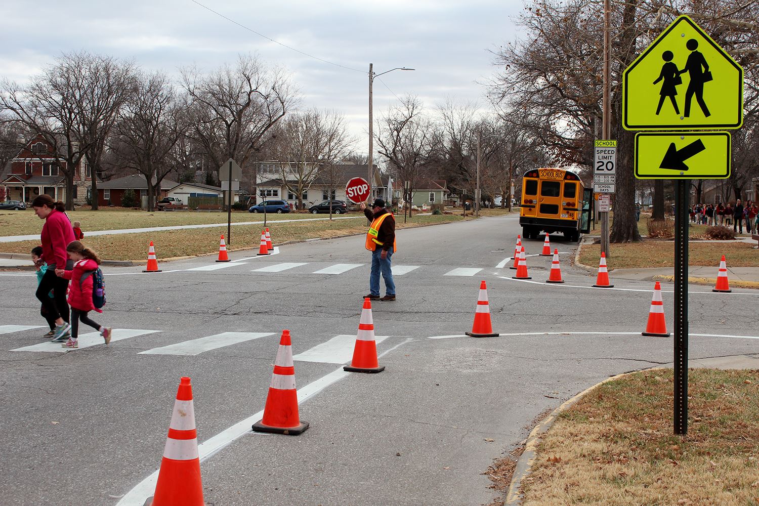 children and parents using a crosswalk